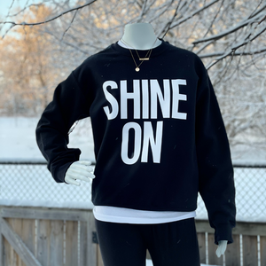 mannequin wearing Shine on Unisex sweater outside 