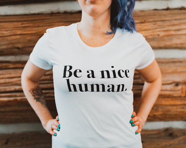 woman modeling t shirt with saying be a nice human 