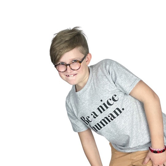 boy with glasses smiling for camera 