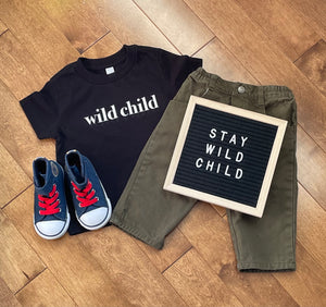 toddler clothing with stay wild child sign 
